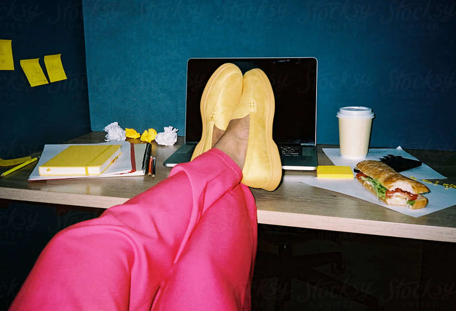 Someone working with their feet up on the desk